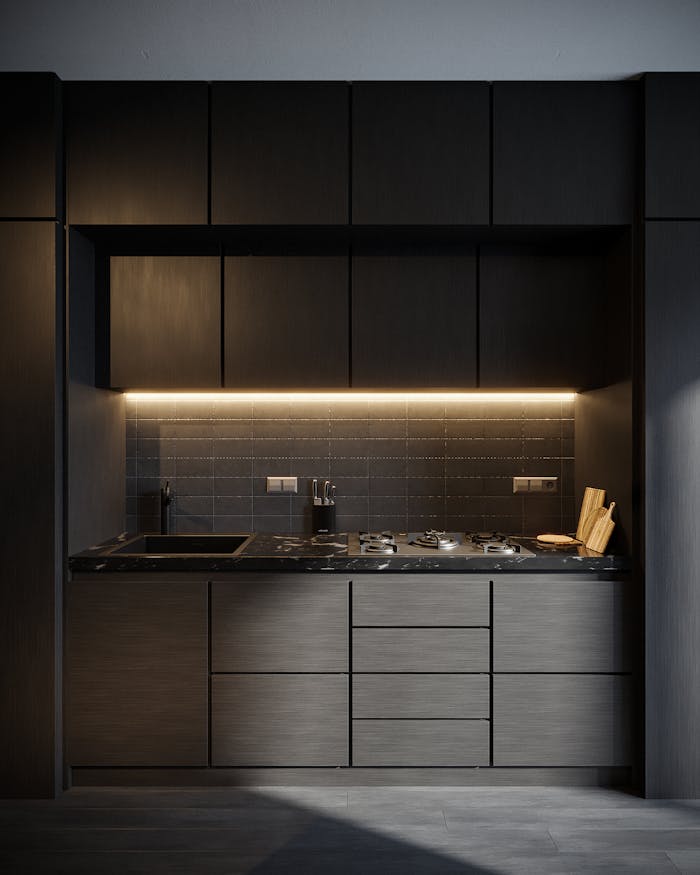 ours-journey Dark-themed modern kitchen featuring sleek cabinets, sink, and stove with ambient lighting.