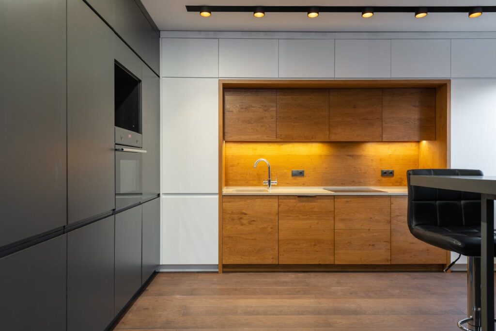 Explore a sleek and contemporary kitchen with wood accents and ample lighting.